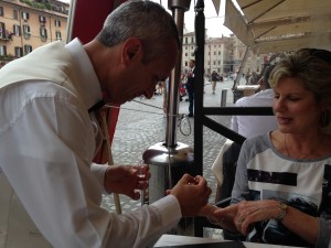 Rome 2 Waiter polishing Sandi's nails at Piazza Navarone restaurant