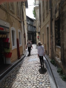 Sandi walking down narrow street Avignon